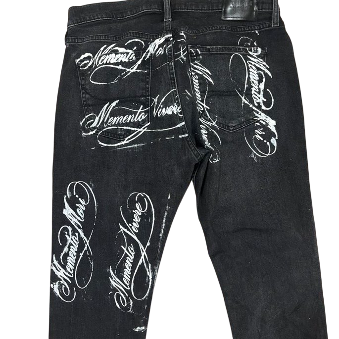 Black denim with Memento Mori and Memento Vivere calligraphy across back pockets and thighs